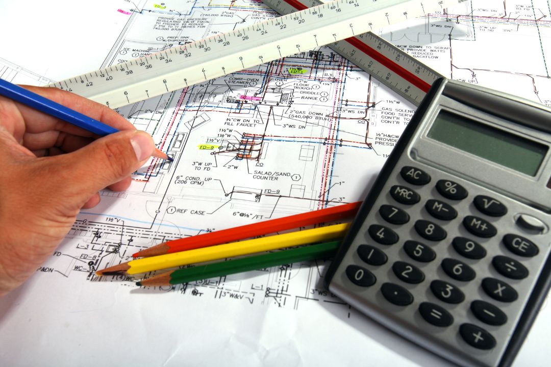 A professional and expert cost estimator working on project blueprints