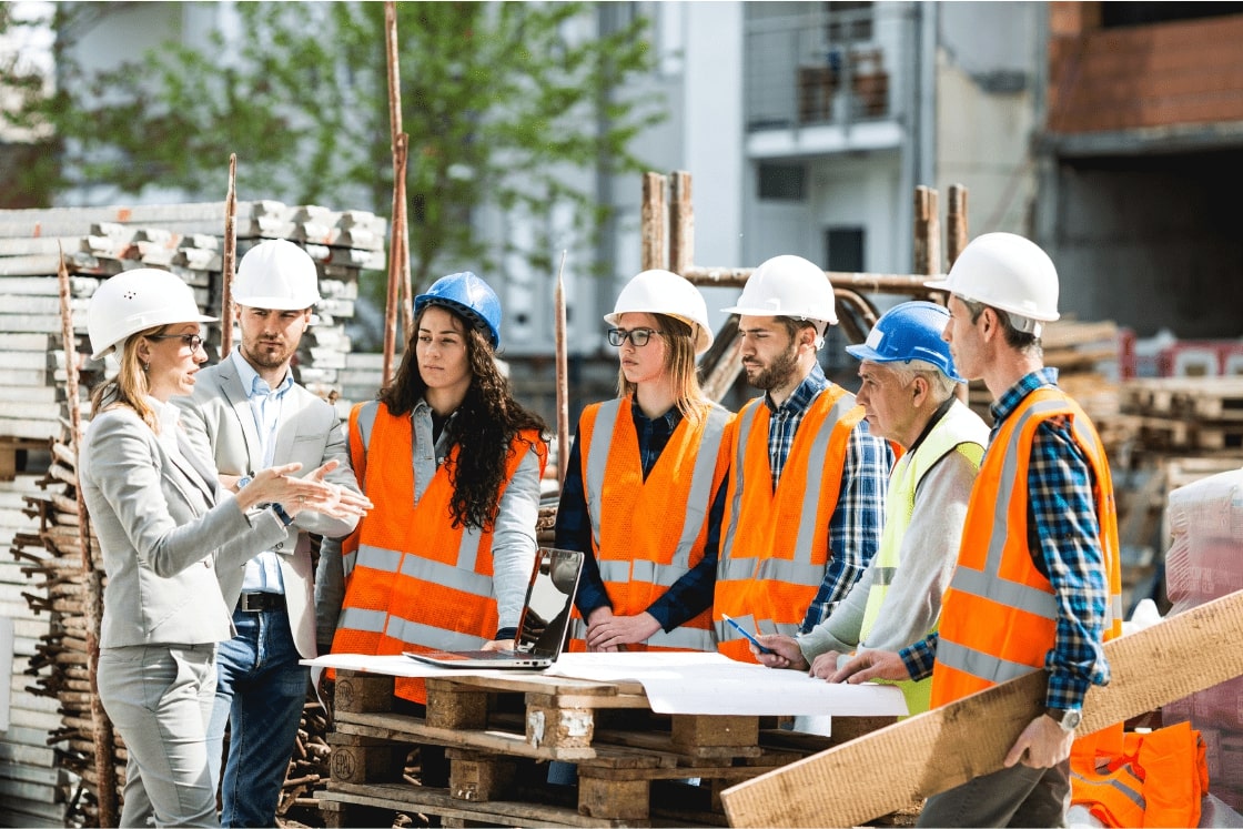 General contractor and subcontractors of various trades discussing quantity takeoffs and estimates for a multi-family commercial project. Expert construction cost estimation services by experienced estimators